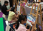 Canvas painting booth at family art event